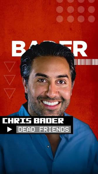 Chris Bader, a Chicago comedian, smiling on stage with a microphone in a comedy club